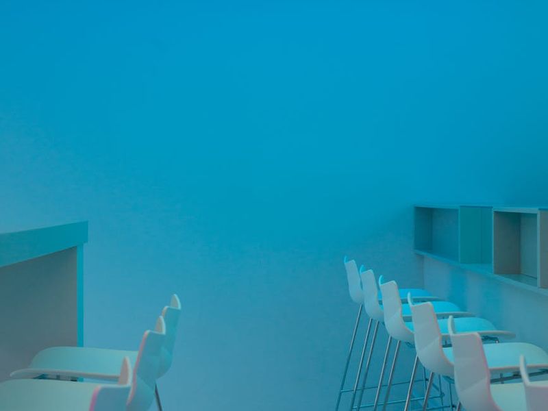 Minimalist workspace with neon lighting and clean lines.